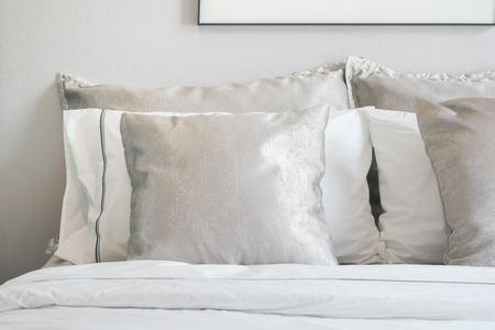 Close up light gray satin pillows on bedの写真素材