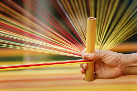   Weaving preparation.     Woman hand working with colorful threads  .の写真素材