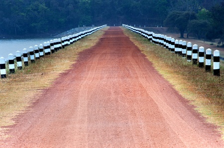 Rural road stretches through the reservoir.の写真素材
