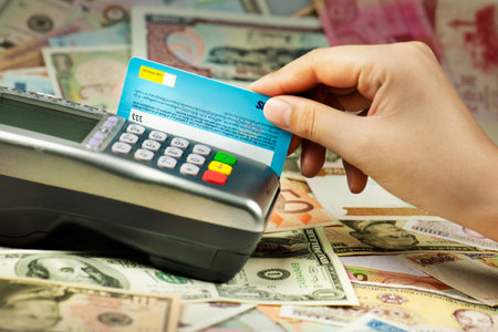 Close-up of human hand putting credit card into payment machine 