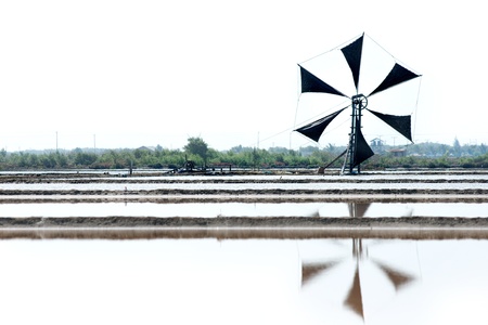 Traditional Thai windmill. To use wind to spin the engine to keep the water in the salt plant.の写真素材