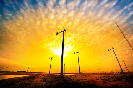 Wind turbines during beautiful sunset . There are new energy of Thailand.の写真素材