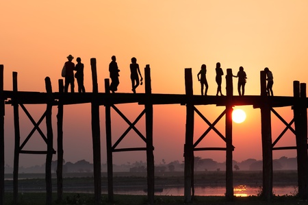 People crossing Ubein bridge at sunset in Mandalay Myanmar  の写真素材