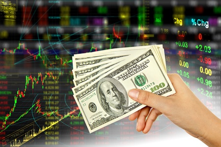 Hand holding dollar in stock background Hand holding dollar in stock background