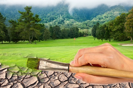 Hand Paint brush dry land to Golf course の写真素材
