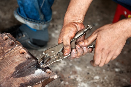 hand holding rusty  adjustable wrenchの写真素材