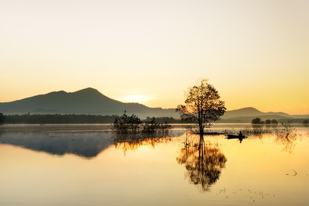 fisherman fishing in big lake ,thailandの写真素材