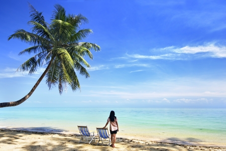 young girl looking sea near her chairの写真素材