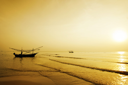 Fisherman paddle boat in sunriseの写真素材