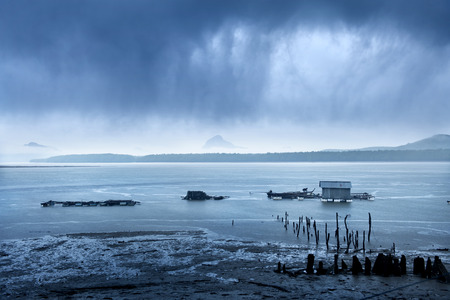 Fisherman  in heavy rainの写真素材