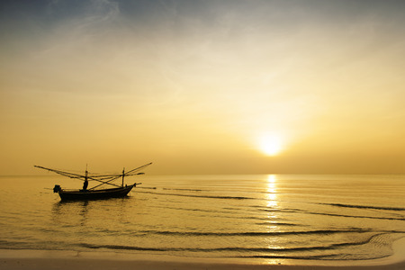 Fisherman paddle boat in sunriseの写真素材