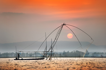 fisherman get fishing nets from lakeの写真素材