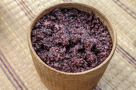 Black sticky rice on  wicker container on the mat.That was  very delicious.の写真素材