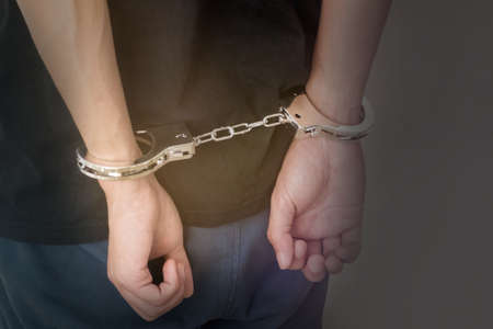 hands of arrested man with handcuffsの写真素材
