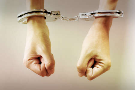 Hands with handcuff.Concept of arrestの写真素材