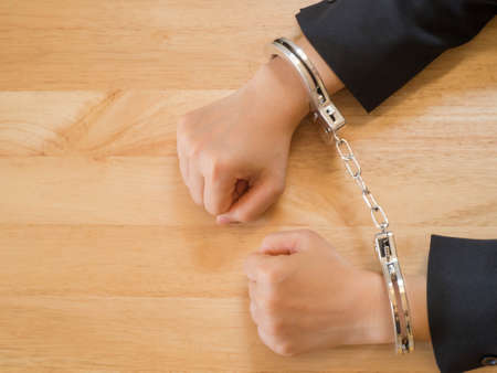 Hand of business female with handcuff. Concept of arrest,corruptionの写真素材