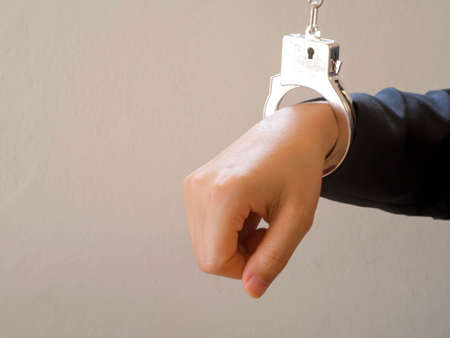 Hand with handcuff.concept of arrest,illegalの写真素材