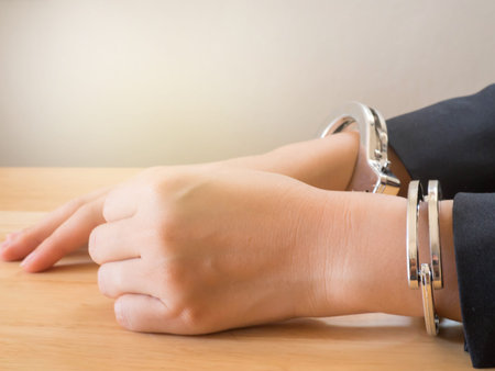 Hand of business female with handcuff. Concept of arrest,corruption