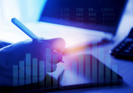 Hand writing on tablet computer screen; Business plan or business strategy; Statistic  and graph of marketing informationの写真素材