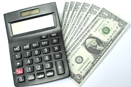 money and calculator isolated on white backgroundの写真素材