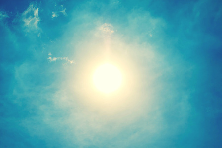The sun shining brightly against the blue sky backgroundの写真素材