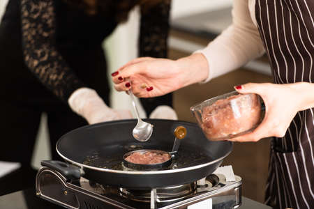 Cooking for breakfast,hamburgersの写真素材