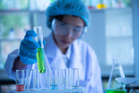 Young women Asian scientist is testing and experimenting with biology to find a vaccine to kill the virus.の写真素材