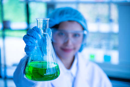 Young women Asian scientist is testing and experimenting with biology to find a vaccine to kill the virus.の写真素材