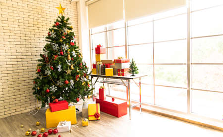 Christmas background with Christmas toys on the Xmas tree and giftの写真素材