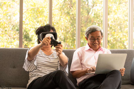 Senior couples relax on holiday with modern technologeの写真素材