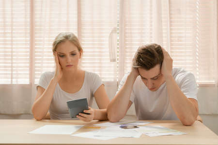 Couples with financial problems Being in a stressful mood and finding a solution for family financial problems, Need to talk about financial plans with financial advisors.の写真素材