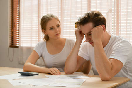 Couples with financial problems Being in a stressful mood and finding a solution for family financial problems, Need to talk about financial plans with financial advisors.の写真素材