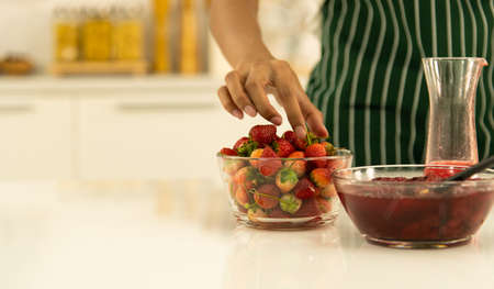 Both of chef making strawberry smoothie in kitchenの写真素材