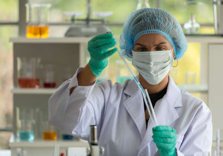 Women in the chemistry laboratory in the science laboratory,nalyzing and experimenting chemical formulasの写真素材
