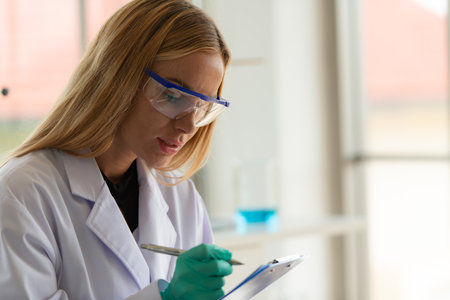 Women in the chemistry laboratory in the science laboratory,nalyzing and experimenting chemical formulasの写真素材