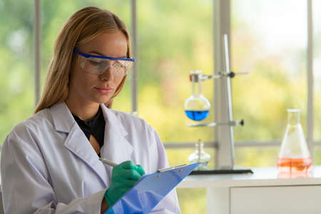 Women in the chemistry laboratory in the science laboratory,nalyzing and experimenting chemical formulasの写真素材