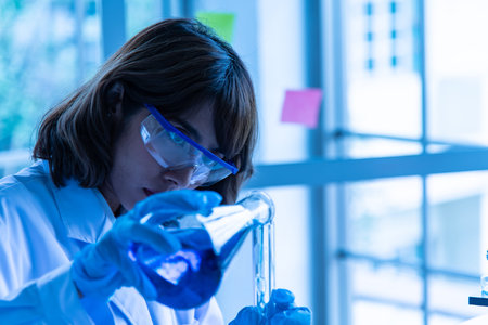 Asian woman in lab testing chemical testing medical,Colored liquids