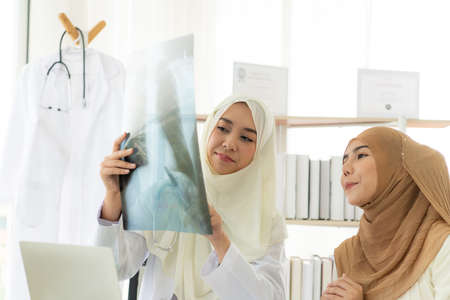 Muslim doctors explain the health examination results of Muslim women. That receives annual health checks Which the results came out good.の写真素材