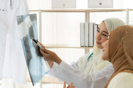 Muslim doctors explain the health examination results of Muslim women. That receives annual health checks Which the results came out good.の写真素材