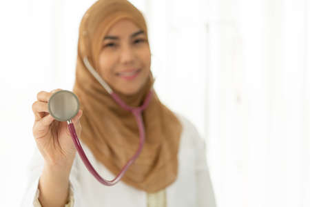 Closeup portrait of Muslim doctors sit and work in the doctor's room. Think and analyze the results of the examination.の写真素材
