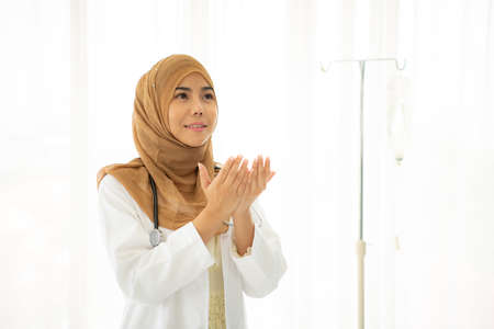 Closeup portrait of Muslim doctors sit and work in the doctor's room. Think and analyze the results of the examination.の写真素材