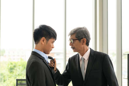 Senior businessmen are angry with unsuccessful new subordinates. With a tantrum and anger In an entirely closed room in the office.の写真素材