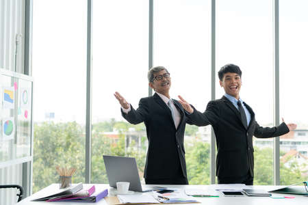 Senior businessmen are happy with new subordinates and appreciation for each other for the project they are responsible successful.の写真素材