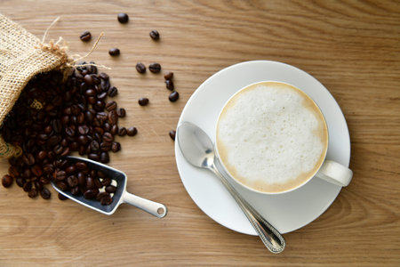 Morning hot coffee for those who love to drink coffee And roasted coffee beans in a sack poured on a...