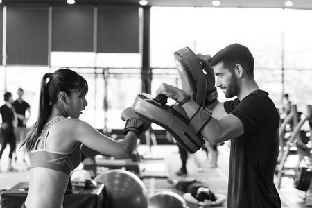 Young couples work out at the gym to strengthen the body. Each person recommends exercise for each...