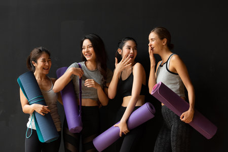 Yoga class of young people interested in yoga activities With a yoga teacher who helps teach yoga postures to students In order to be physically strong and flexible.の写真素材