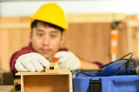Asian young man carpenter work for customers meticulously He is a young man, a successful entrepreneur and very skilled.の写真素材