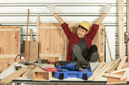 Asian young man carpenter work for customers meticulously He is a young man, a successful entrepreneur and very skilled.の写真素材