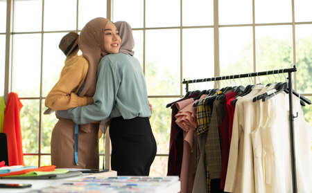 Muslim women run a small business in their own homes. Is the design and tailoring of clothes.の写真素材