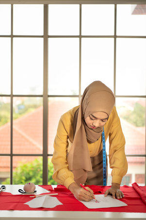 Muslim women run a small business in their own homes. Is the design and tailoring of clothes.